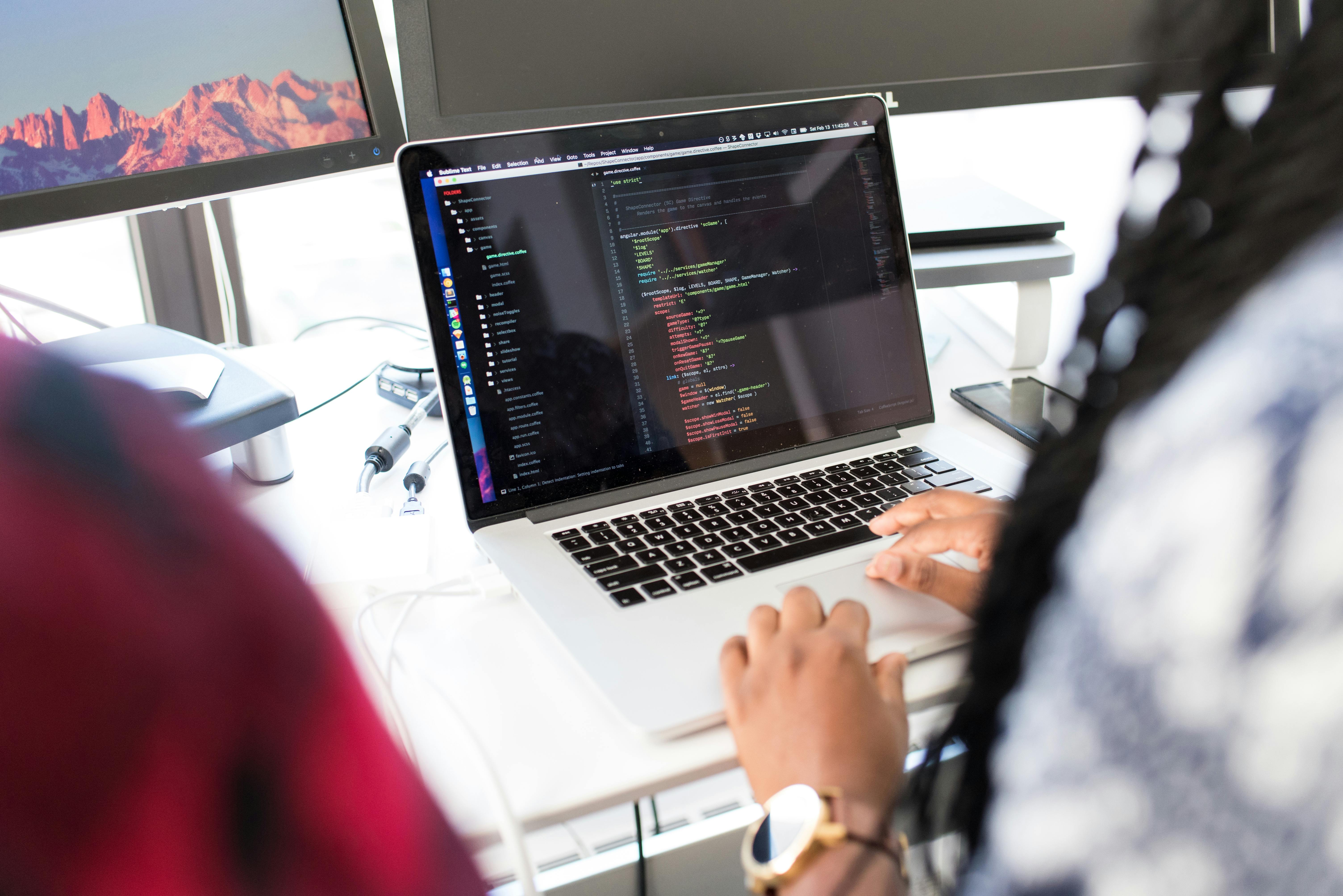 Developer coding on laptop showing web development in action